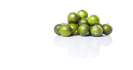 Calamondin or calamansi lime over white background