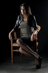 Obraz na płótnie Canvas brunette sitting on a chair