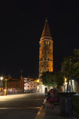 Fototapeta na wymiar Caorle, Italy Nighttime on Romanesque leaning bell tower