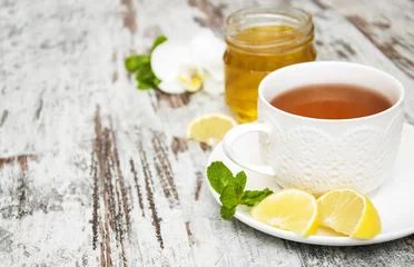 Fotobehang Thee Kopje thee met citroen en honing
