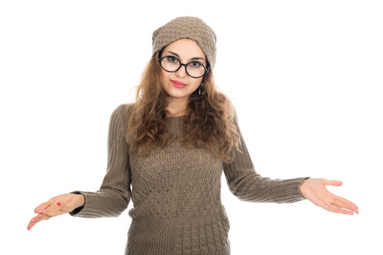 Surprised girl in glasses with arms spread apart.
