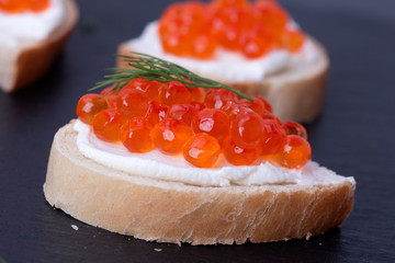 Bread with fresh cream cheese and red caviar