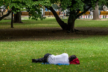 Mann schläft im Park