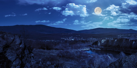 lake in mountains quarry near city at night © Pellinni