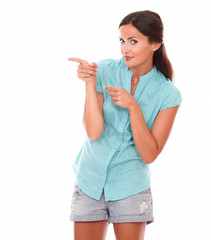 Pretty hispanic woman in short jeans pointing