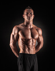 Fototapeta na wymiar Muscular man on black background