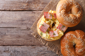 bagel with egg and bacon close-up. horizontal view from above