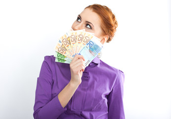 Young red-haired girl with euro banknotes.