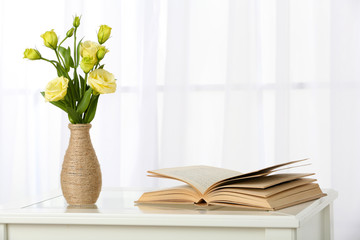 Beautiful bouquet of flowers in vase on window background