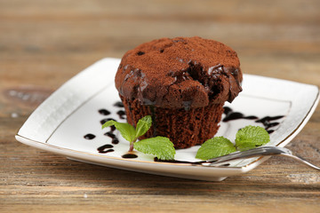 Fototapeta na wymiar Yummy chocolate cupcake on table