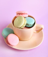 Assortment of gentle colorful macaroons in colorful mug