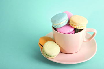 Assortment of gentle colorful macaroons in colorful mug
