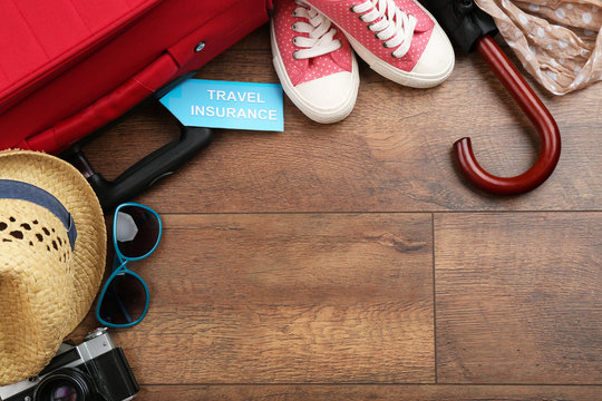 Suitcase and tourist stuff with inscription travel insurance