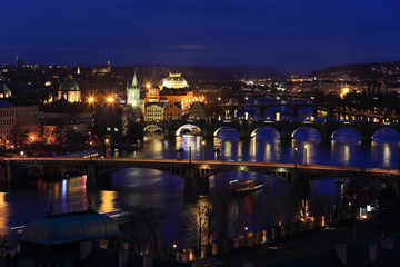 Fototapeta na wymiar Winter night Prague City with its Bridges above River Vltava