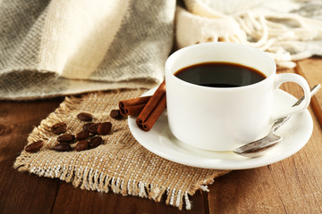 Obraz na płótnie Canvas Cup of coffee with coffee beans and cinnamon