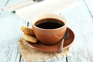Cup of coffee with newspaper
