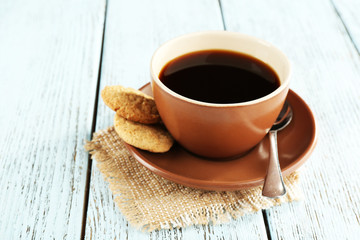 Cup of coffee with cookies and spoon