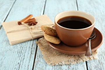 Cup of coffee with spoon and cookies