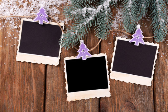 Blank photo frames and Christmas decor with snow fir tree
