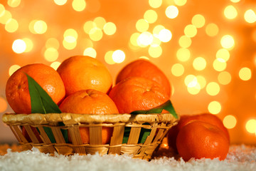 Obraz na płótnie Canvas Fresh ripe mandarins on snow, on lights background
