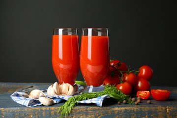 Glasses of tasty tomato juice and fresh tomatoes