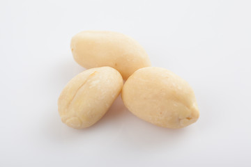 Peeled peanuts on white background