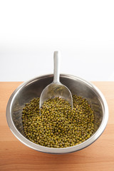 Mung beans in bowl with transfer scoop