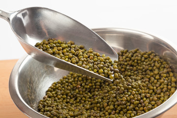 Mung beans in bowl with transfer scoop