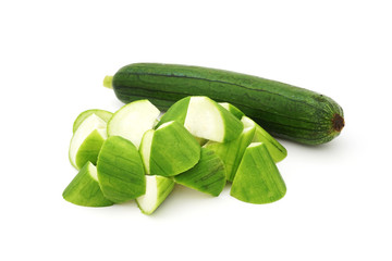 raw chopped luffa cylindrica on white background