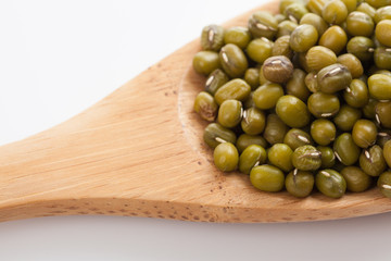 Mung beans with wooden spoon