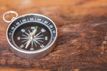 Fototapeta na wymiar Close up compass on wood background