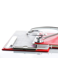 Stethoscope with red medical clipboard