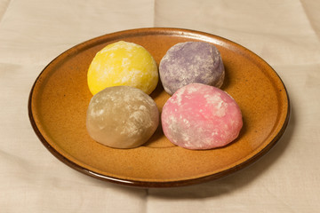 four color daifuku  on the brown dish