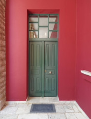 colorful building detail, green door, red wall