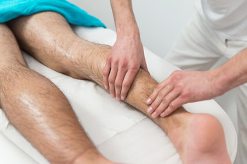 Fototapeta na wymiar Man Having Legs Massage In A Spa Center