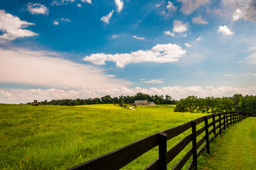 Fototapeta na wymiar Beautiful summer sky over fence and estate in Southern York Coun