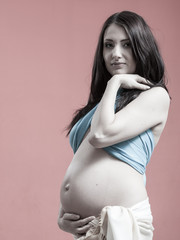 Attractive pregnant woman touching her belly