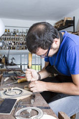 luthier working a guitar rosette