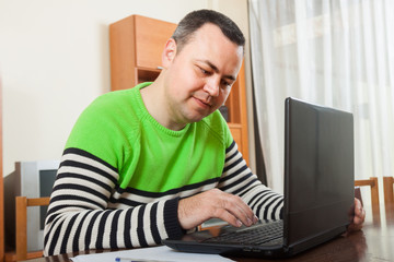  man  sitting at work on laptop