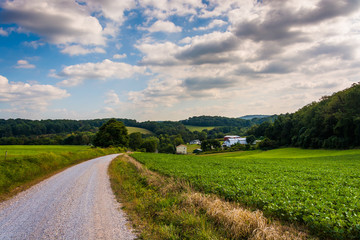 Cloudy sky over a dirt road and farm fields in rural York County