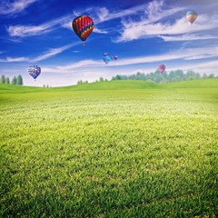Fototapeta premium Summer field with lot of air balloons over horizon, abstract lan
