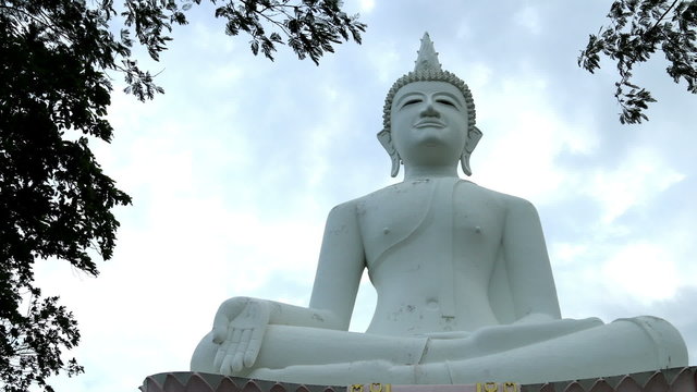 Timelapse white Buddha statue, Clouds runing background.