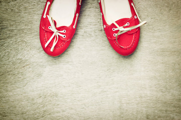 top view of red worn woman shoes over wooden textured background