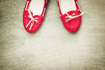 top view of red worn woman shoes over wooden textured background