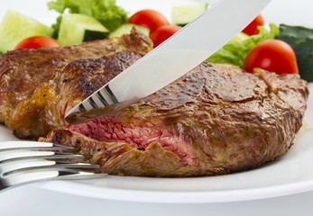 Juicy steak with fork and knife