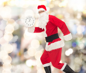 man in costume of santa claus with clock