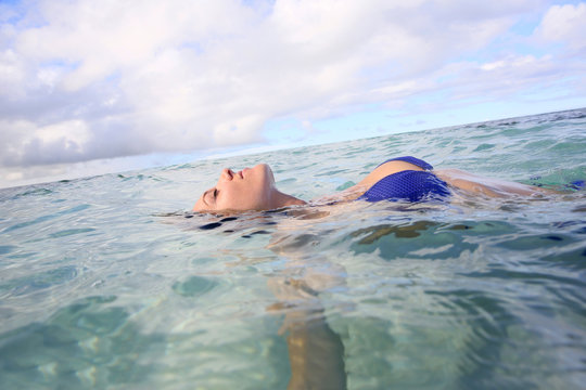 Closeup of woman floating in lagoon water