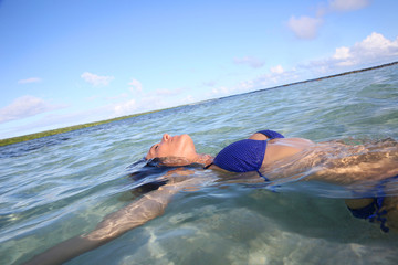 Closeup of woman floating in lagoon water