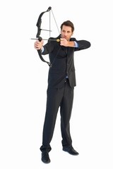 Concentrated handsome businessman practicing archery