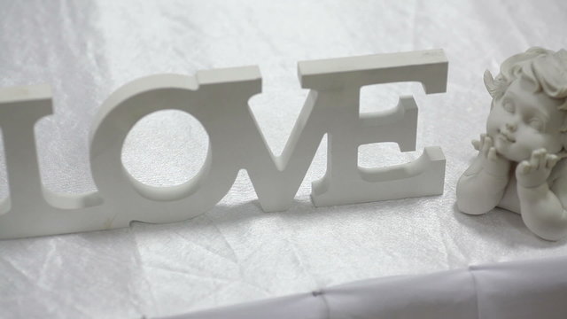 wooden sign LOVE on wedding table